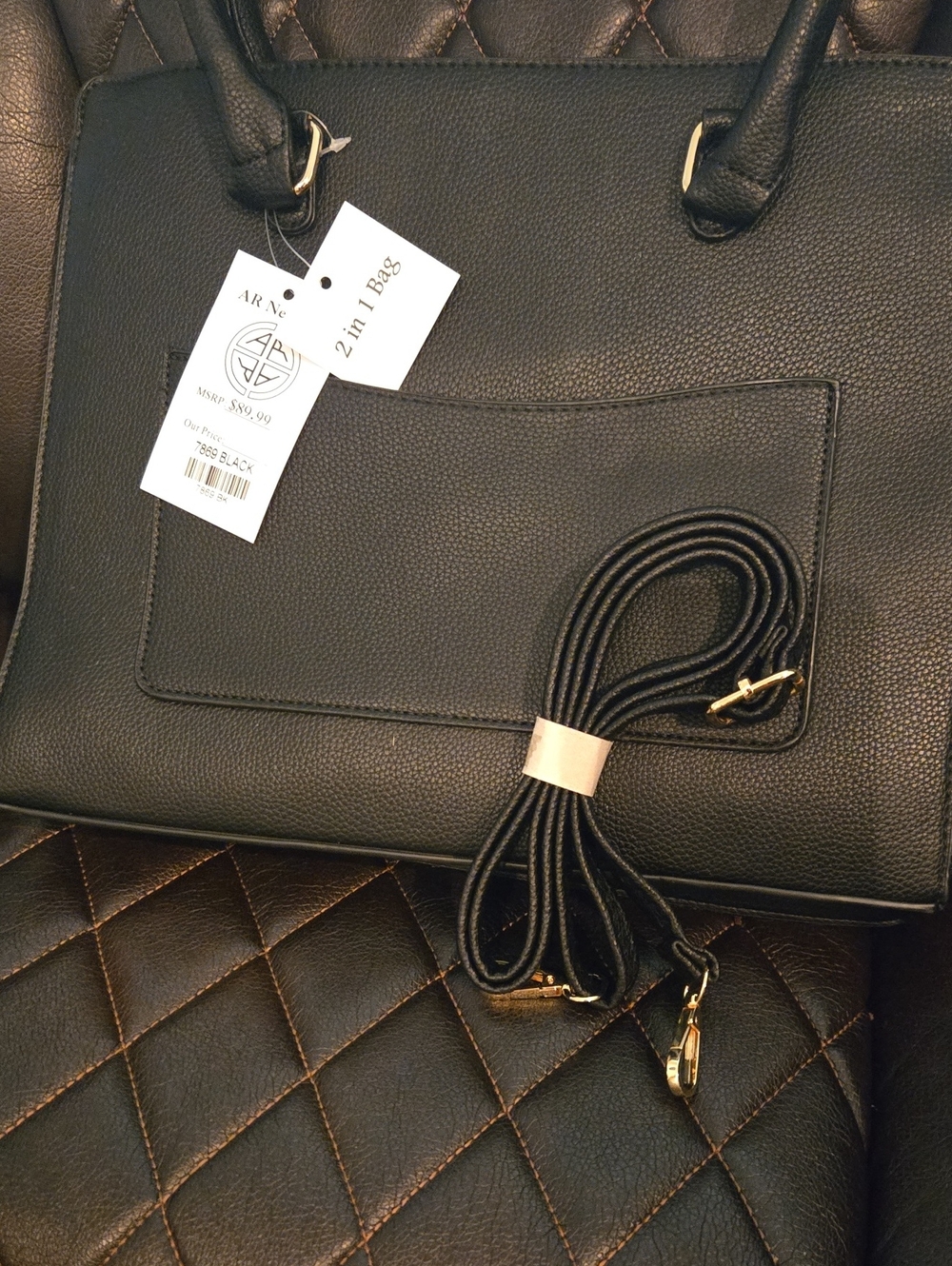 2-in-1 Black Structured Tote Bag With Cross body strap and cosmetic bag inside.